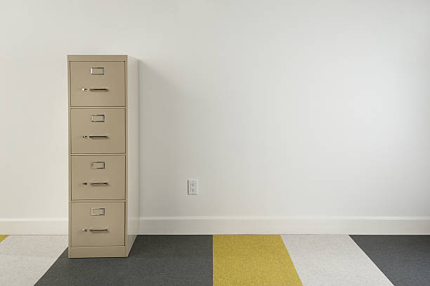 Modern Home Office File cabinet in empty modern home office. The striped carpeting is made of a felt material. filing cabinet photos stock pictures, royalty-free photos & images