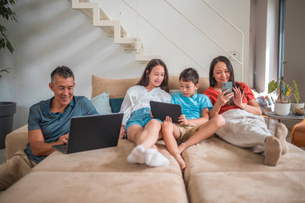 istock Asian Family Bonding at Home Using Portable Devices 1640033475