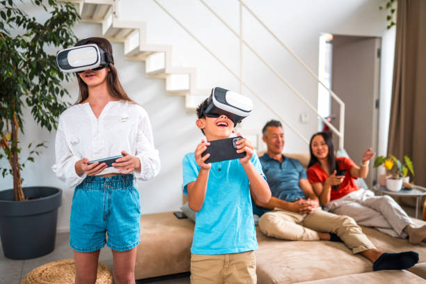 Asian brother and sister are captured in a moment of excitement as they play video games on a VR set. In the background, their father and mother relax on a cozy sofa, enjoying TV entertainment.