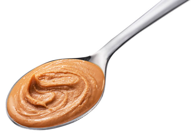 istock Peanut butter in spoon on white background. Clipping path. 1640041554
