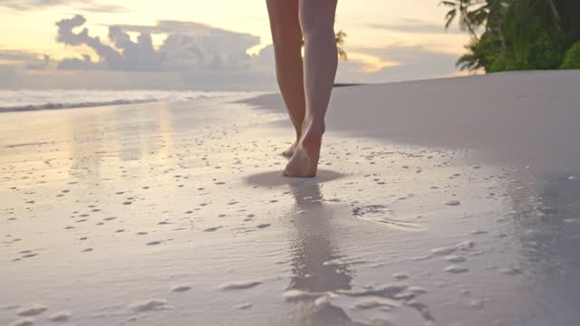 Low angle view of woman walking at the beach
