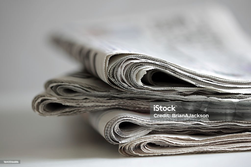 Newspaper edges with white background Newspapers folded and stacked concept for global communications Press Release Stock Photo