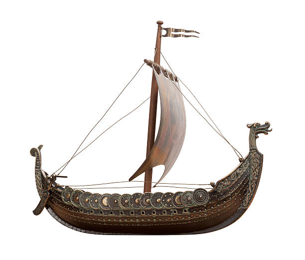 A Viking ship isolated on white Side view of a Viking Ship isolated on white background.  The ship shows a dragon head at the front and the back. There is a row of shields along the side of the hull. The sail is supported by a wooden mask. viking ship photos stock pictures, royalty-free photos & images