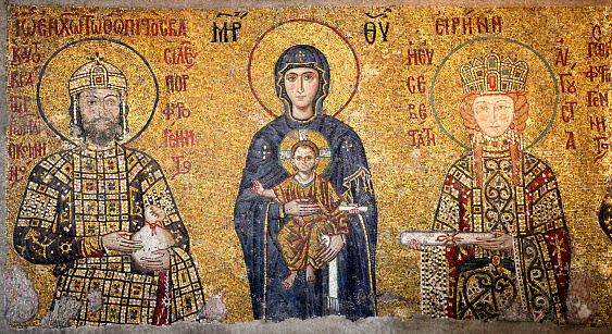 The Mosaics of the Comnenus located on the eastern wall of the southern gallery of Hagia Sophia in Istanbul, date from 1122. The Virgin Mary is standing in the middle, depicted, as usual in Byzantine art, in a dark blue gown. She holds the Child Christ on her lap