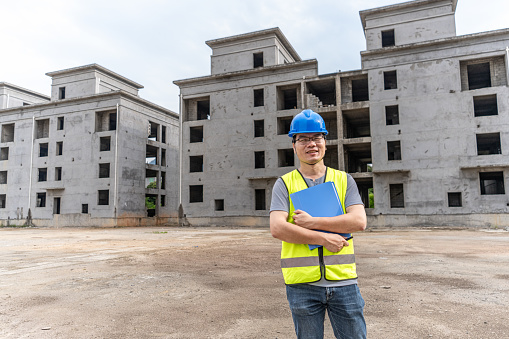 A male engineer is inspecting the construction site