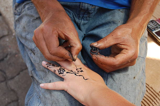 istock Artist painting henna on her hand 164010280