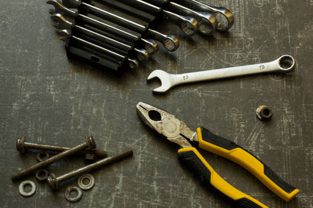 istock Tool set of pliers, wrenches, bolts and nuts on abstract grey surface 1640103691
