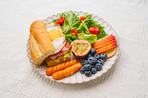 breakfast sandwich Avocado Fried Eggs with Bacon, Vegetables and Fruit
