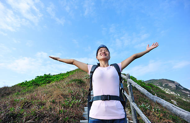 istock young woman open arms in mountain 164011048