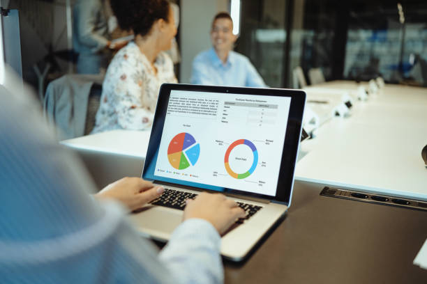 istock Group of business people working in team in modern corporate office and using financial data on device screen 1640112747