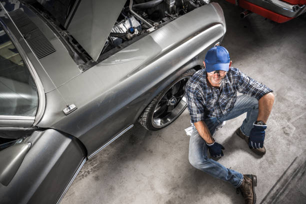 istock Smiling Caucasian Car Mechanic and His Workshop 1640115447