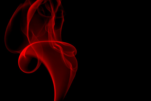 Bright red smoke flame on black background