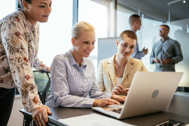 istock Businesswomen working in multi ethnic team in modern corporate office and using laptop for business correspondence 1640119798