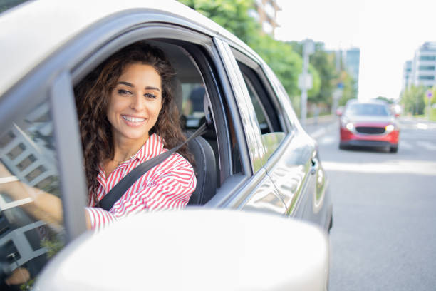 istock Woman is driving a car on her way to work 1640127824