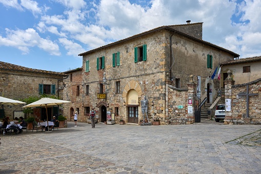 Monteriggioni, Italy – May 25, 2023: A scenic view of old stone houses in Monteriggioni, Italy