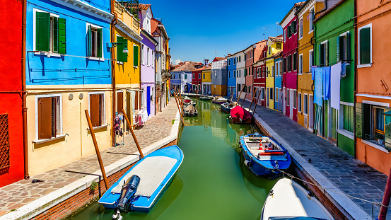 Beautifully colored buildings next to narrow canals on the Italian island of Burano, near Venice