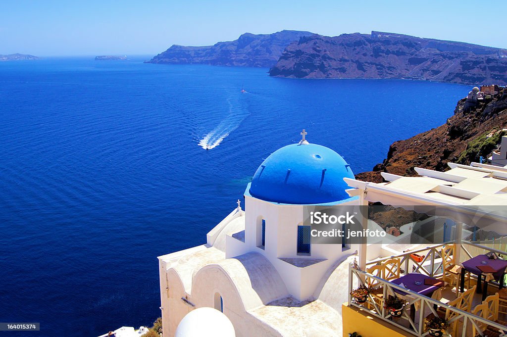 Blue and white church with boat, Oia, Santorini, Greece Famous blue dome church with boat, Oia village, Greece Aegean Sea Stock Photo