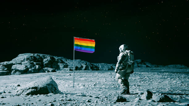 istock Rainbow colored flag stands on the surface of a moon 1640155384