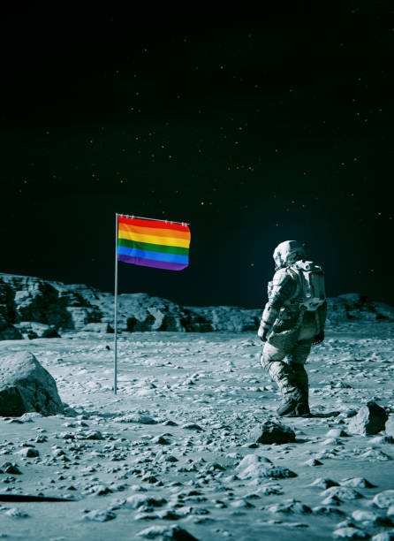 istock Astronaut on space mission walks towards rainbow colored flag on planet 1640155445