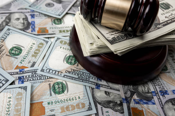 istock 100 dollar bills with judge hammer 1640158551