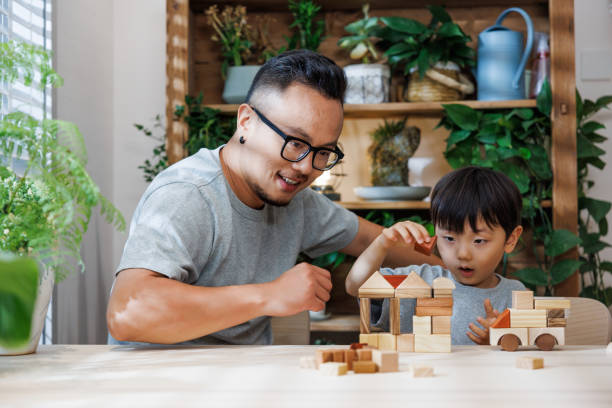 istock Dad and his son are building blocks at home 1640161193