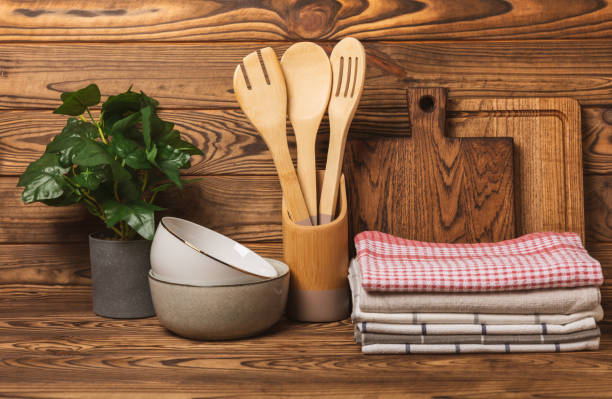 istock Kitchen towel. Kitchen utensils and textiles. A stack of cotton towels on the table. Stylish kitchen interior with utensils and crockery on kitchen wooden table.Place for text. copy space. 1640187710