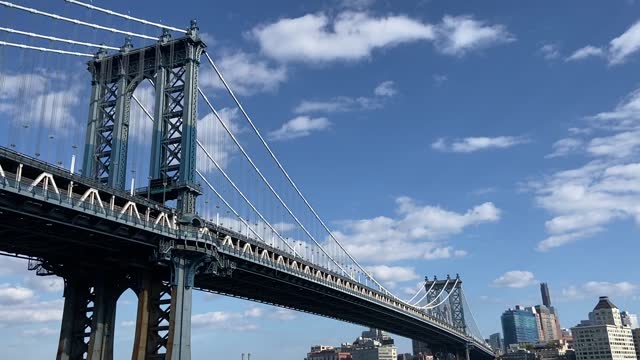 View of the Manhattan Bridge while driving underneath it on the FDR Drive in Manhattan on a summer day in New York City