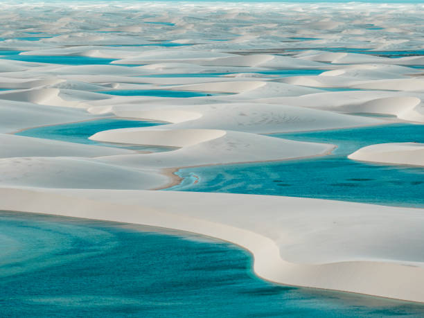 Aerial view of Lencois Maranhenses. White sand dunes with pools of fresh and transparent water. Brazil Aerial view of Lencois Maranhenses. White sand dunes with pools of fresh and transparent water. Desert. Barreirinhas. Maranhao State National Park. Brazil brazil desert maranhao state national park stock pictures, royalty-free photos & images