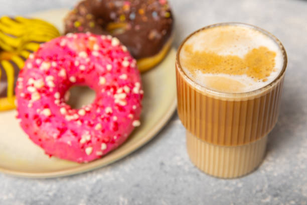istock Modern coffee machine with a cup and donut on the kitchen table. Coffee house. Modern espresso coffee machine with a cup in the kitchen. Preparation of a fragrant hot drink. Place for text.Copy space. 1640205198