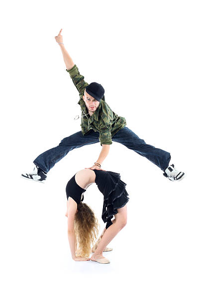 istock Gymnast does bridge and smiling rapper jump above her 164021921