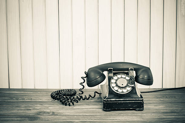 istock Vintage telephone on old table sepia photo 164022330