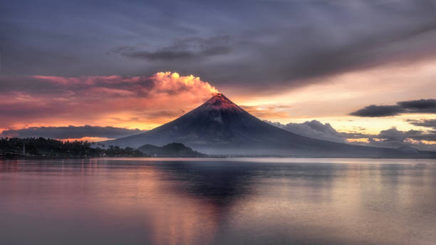 Mayon Volcano at the lake and beautiful sunrise in Lagazpi city, Albay Province,Philippines. Mayon Volcano at the lake and beautiful sunrise in Lagazpi city, Albay Province,Philippines. philippines landscape stock pictures, royalty-free photos & images