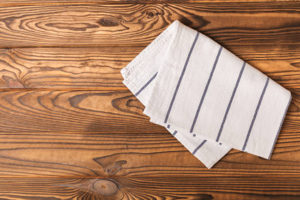 istock Kitchen towel. Kitchen utensils and textiles. A stack of cotton towels on the table. Stylish kitchen interior with utensils and crockery on kitchen wooden table.Place for text. copy space. 1640224891