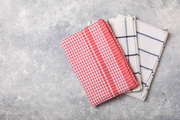 istock Kitchen towel. Kitchen utensils and textiles. A stack of cotton towels on the table. Stylish kitchen interior with utensils and crockery on kitchen wooden table.Place for text. copy space. 1640224937