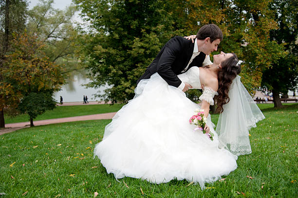 istock Newly married couple dancing in field 164023767