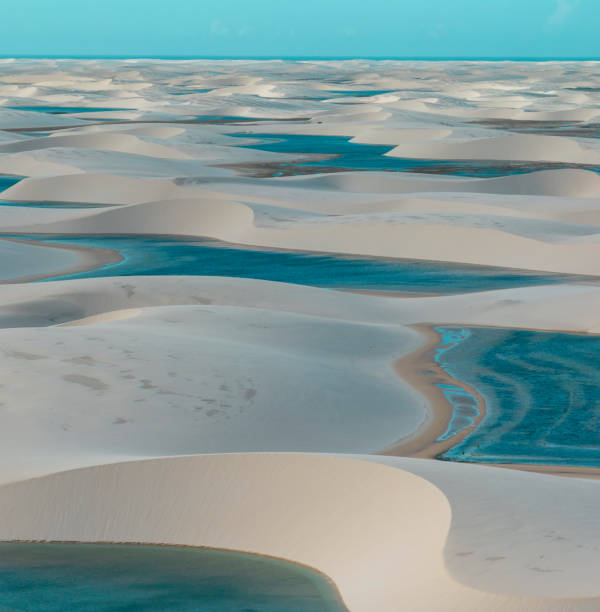 Aerial view of Lencois Maranhenses. White sand dunes with pools of fresh and transparent water. Brazil Aerial view of Lencois Maranhenses. White sand dunes with pools of fresh and transparent water. Desert. Barreirinhas. Maranhao State National Park. Brazil brazil desert maranhao state national park stock pictures, royalty-free photos & images