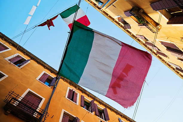 istock alley in Venice with Italian flags 164024917