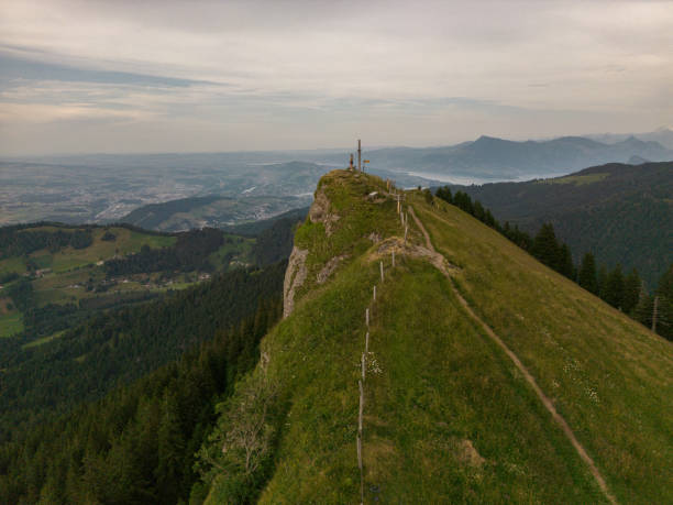 istock Distant woman standing on mountain top 1640250787