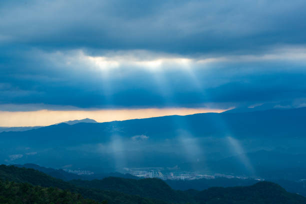 Heavenly Glows: Watch Crepuscular Rays amidst Transforming Clouds on the Peak. The Wufenshan Weather Radar Station stands on the top of the mountain. Taiwan