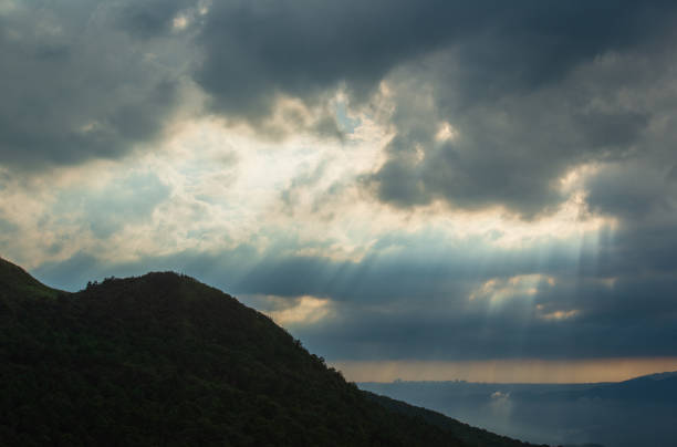 istock Nature's Spectacle: Crepuscular Rays and Shifting Clouds at the Mountain Top. 1640275067