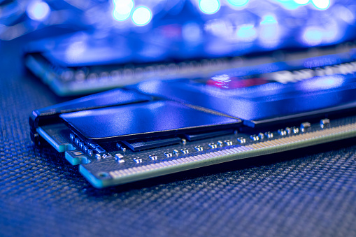 Memory module DDR4 DRAM macro in blue light. Computer RAM chipset. Desktop PC hardware components