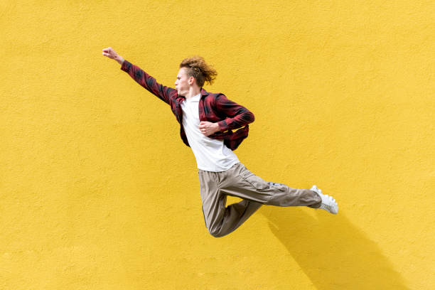 istock young guy student with backpack flies forward and hurries to study, man jumps and runs in the air 1640282046