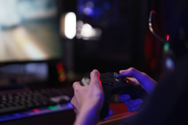istock Hand of female cyber hacker gamer holding controller joystick to playing games on computer 1640282755