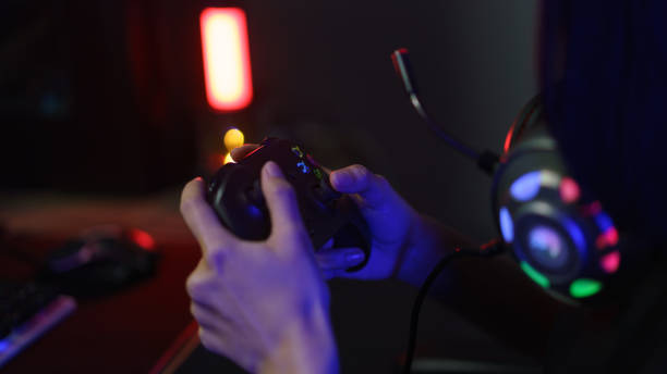 istock Female cyber hacker gamer using controller joystick to playing or streaming games on computer 1640282758