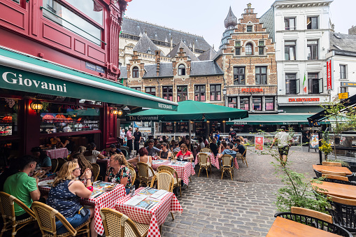 Antwerp, Belgium, August 22, 2023; People enjoy on the terrace in the historic center of Antwerp.