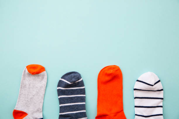 istock Odd socks day concept. Mismatch socks at blue. 1640283761