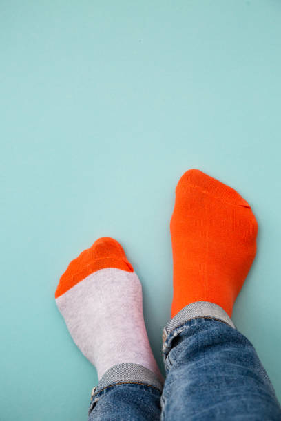 istock Odd socks day concept. Mismatch socks at blue. 1640283836