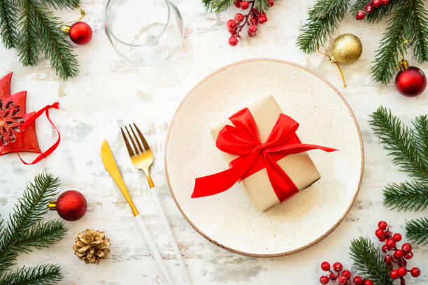 istock Christmas table setting with plate, cutlery and christmas decorations on white background. 1640284514