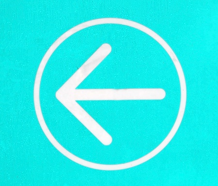 Arrow sign on a turquoise background for direction concepts.