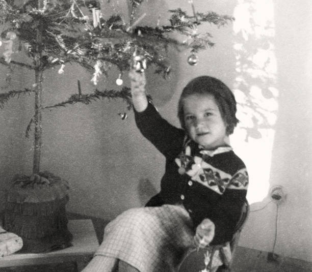 istock Little Girl under Christmas Tree in 1954. 1640297567